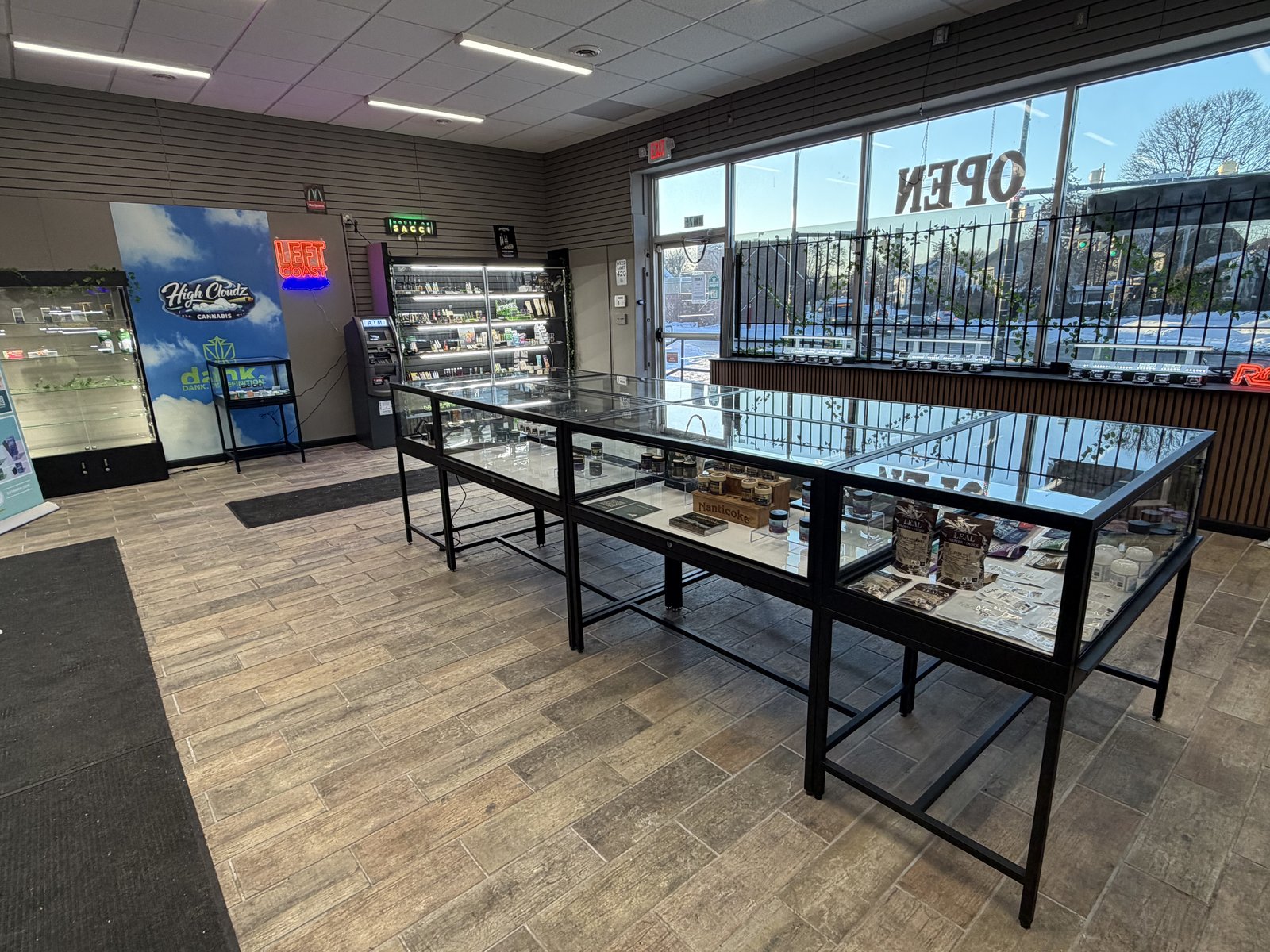 Flower jars and edibles in the glass display case at High Cloudz Buffalo